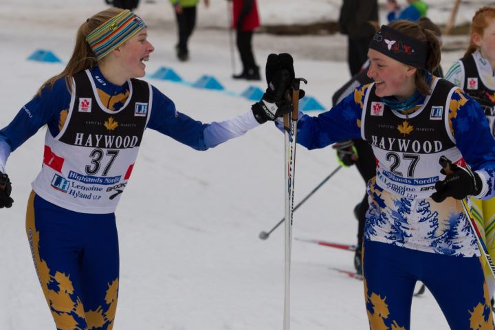 Two alpine-skiers high five at a previous Ontario Winter Games.