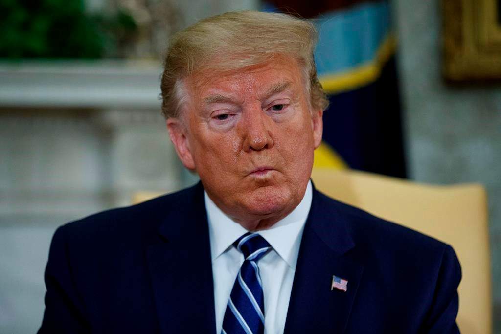 President Donald Trump listens to a question during a meeting with Canadian Prime Minister Justin Trudeau in the Oval Office of the White House, Thursday, June 20, 2019, in Washington.