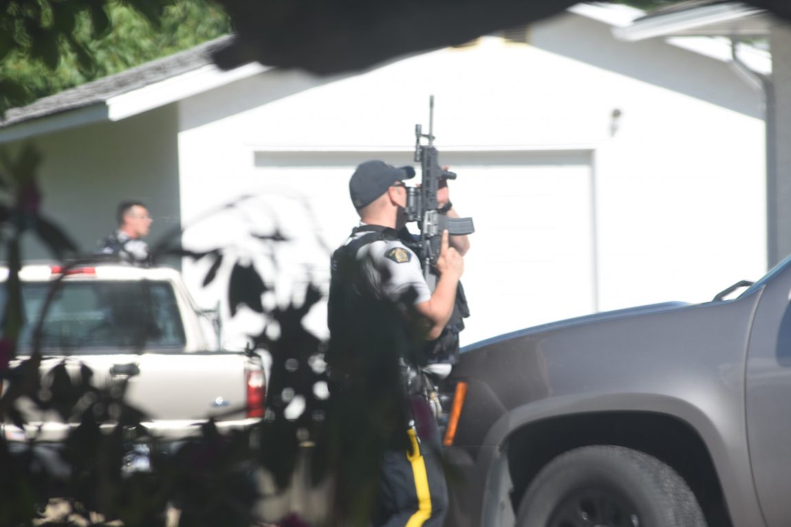 Dozens of police have converged on a Kelowna home where a suspect is said to be holed up.