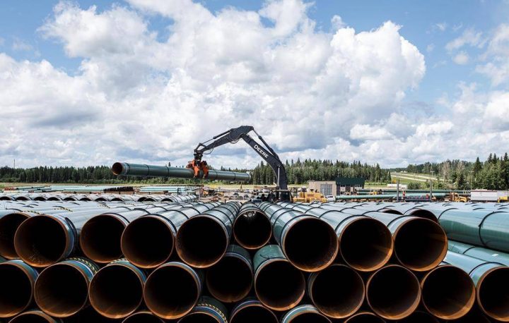 Pipe for the Trans Mountain pipeline is unloaded in Edson, Alta. on Tuesday June 18, 2019. THE CANADIAN PRESS/Jason Franson.