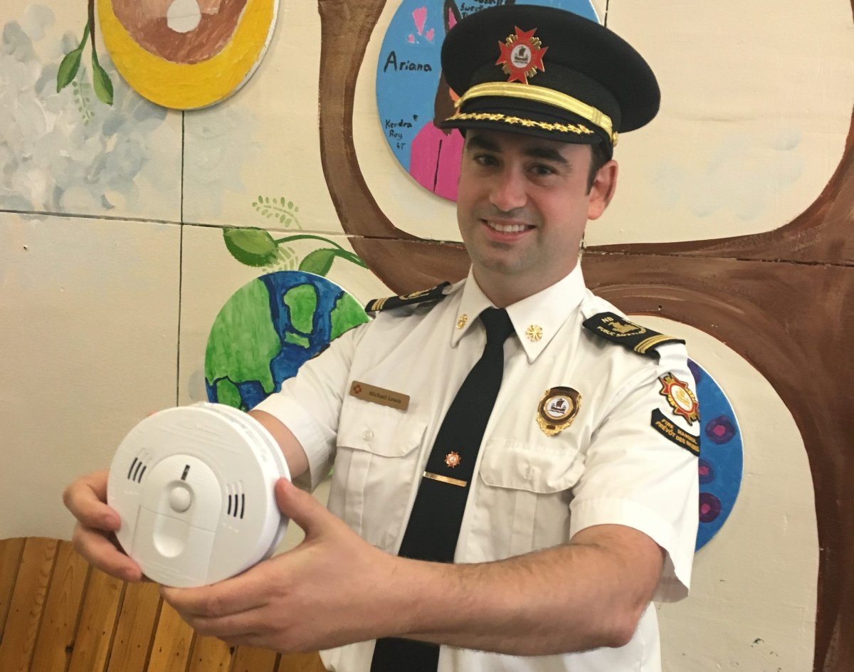 New Brunswick fire marshal Michael Lewis poses with a carbon monoxide monitor on June 18, 2019.
