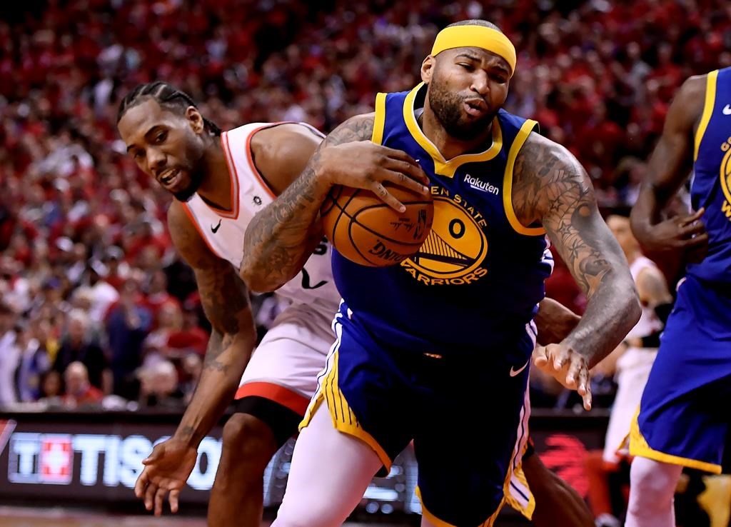 Toronto Raptors' forward Kawhi Leonard looks on as Golden State Warriors centre DeMarcus Cousins stumbles with the ball during second half Game 2 NBA Finals action, in Toronto on Sunday, June 2.