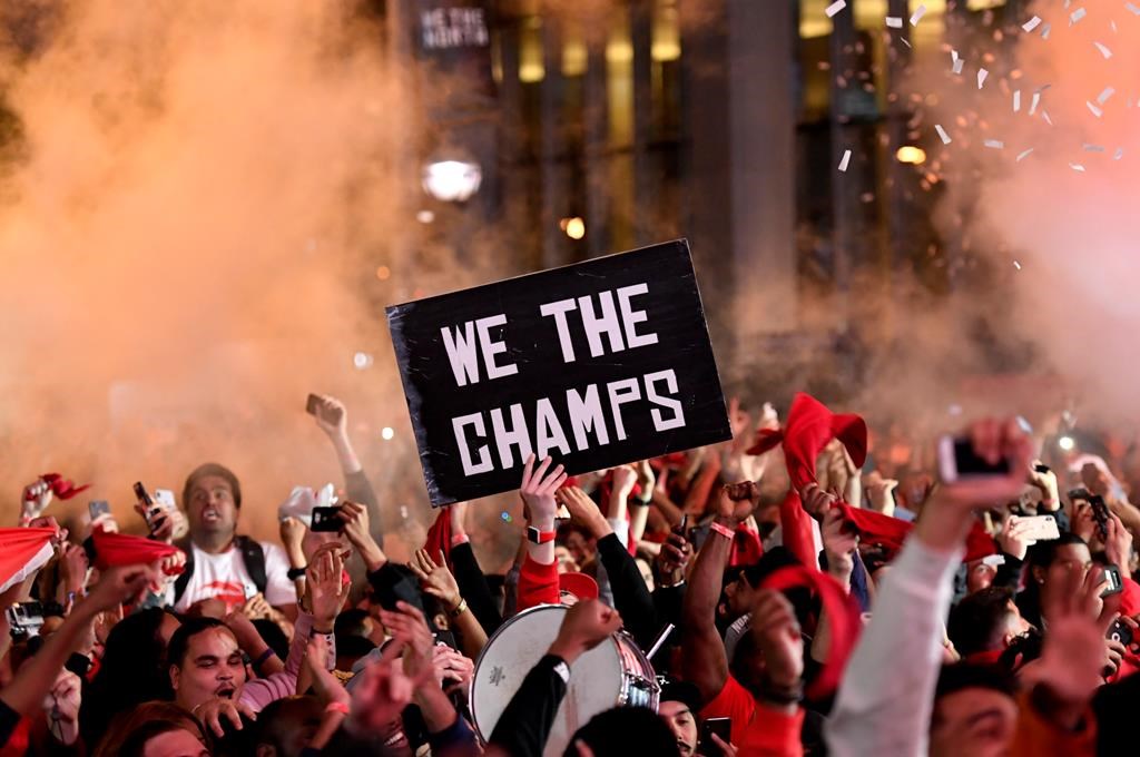 Toronto Raptors fans react at Jurassic Park, outside of the Scotiabank Arena in Toronto, as they watch the Raptors defeat the Golden State Warriors in Game 6 of the NBA Finals to win the NBA Championship, Thursday, June 13, 2019.