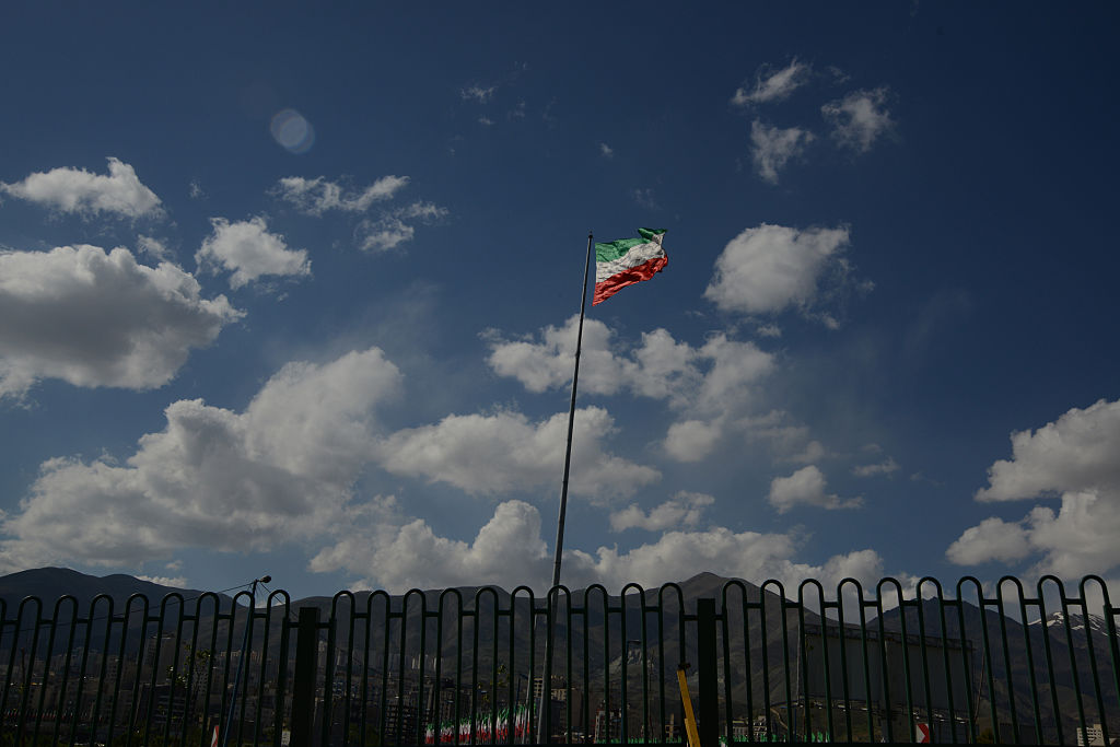 An Iranian flag seen amass against the cloudy blue sky on April 22, 2013 in Tehran, Iran.