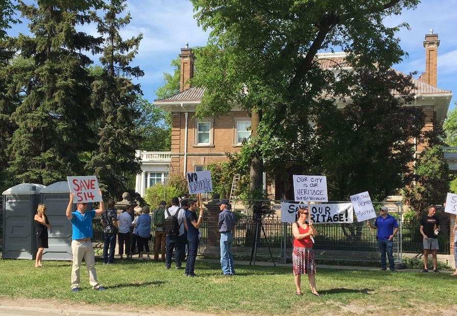 Protesters gather around 514 Wellington Crescent in June.