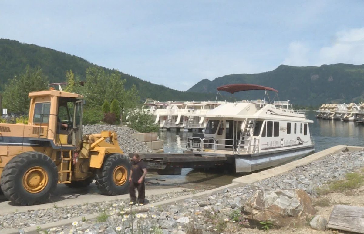 Houseboats owned by Waterway Houseboats are removed from Mara Lake on Wednesday, June 12, 2019. The company went into receivership after suffering devastating losses from flooding in 2012.