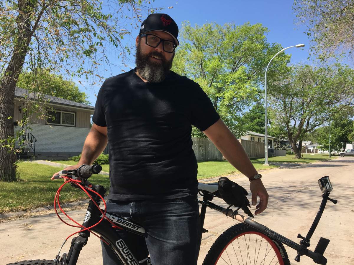 Andrew Wood and Cavalier the crow getting ready for a bike ride.