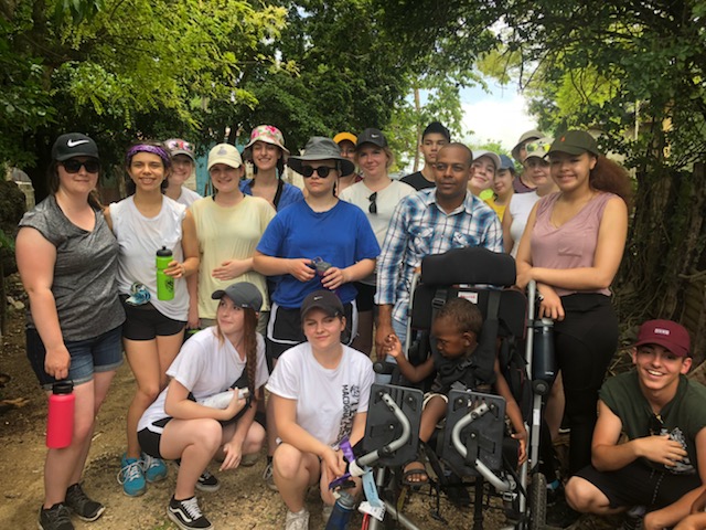 Macdonald High School students brought a wheelchair to a child in a small village in the Dominican Republic.
