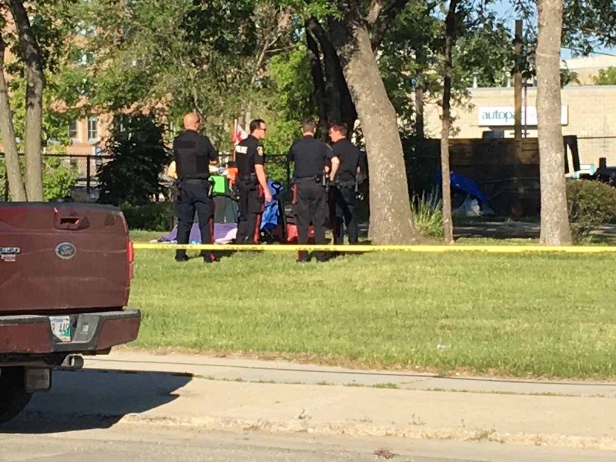 Police gather around on the scene at Higgins Avenue and Maple Street Wednesday.
