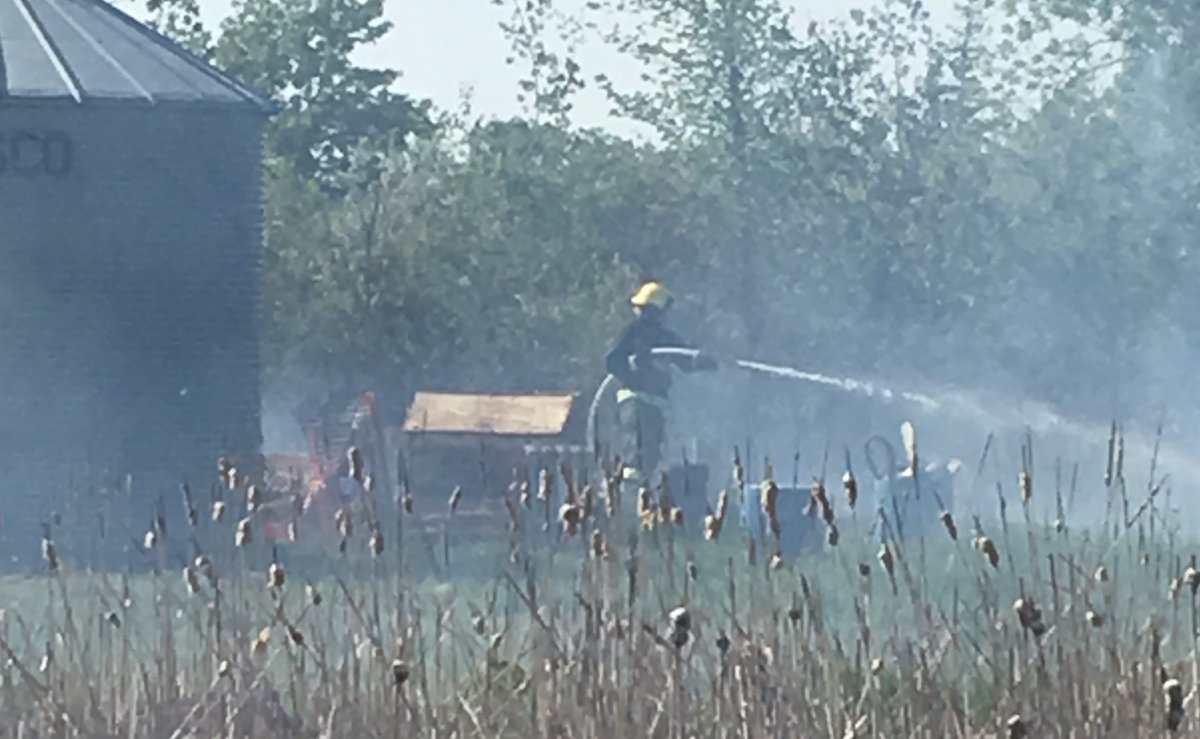 Crews work to contain a grass fire south of the perimeter highway Tuesday afternoon.