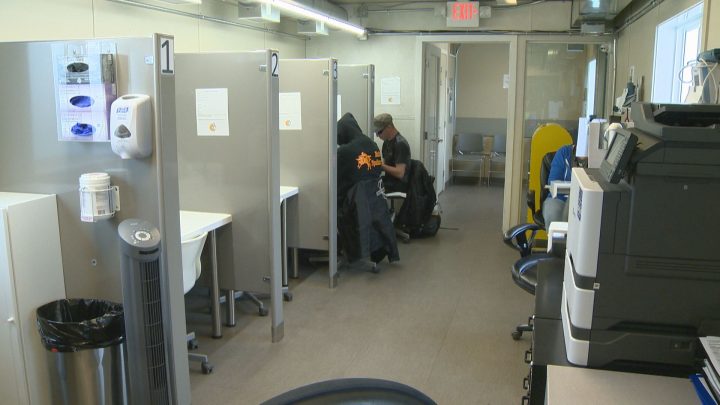 Two clients visit a temporary overdose prevention facility in Red Deer, Alberta in June, 2019.