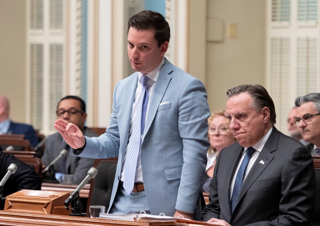 Quebec government House Leader Simon Jolin-Barrette responds to the Opposition during question period Friday, June 14, 2019 at the legislature in Quebec City. Francois Legault, right, looks on.