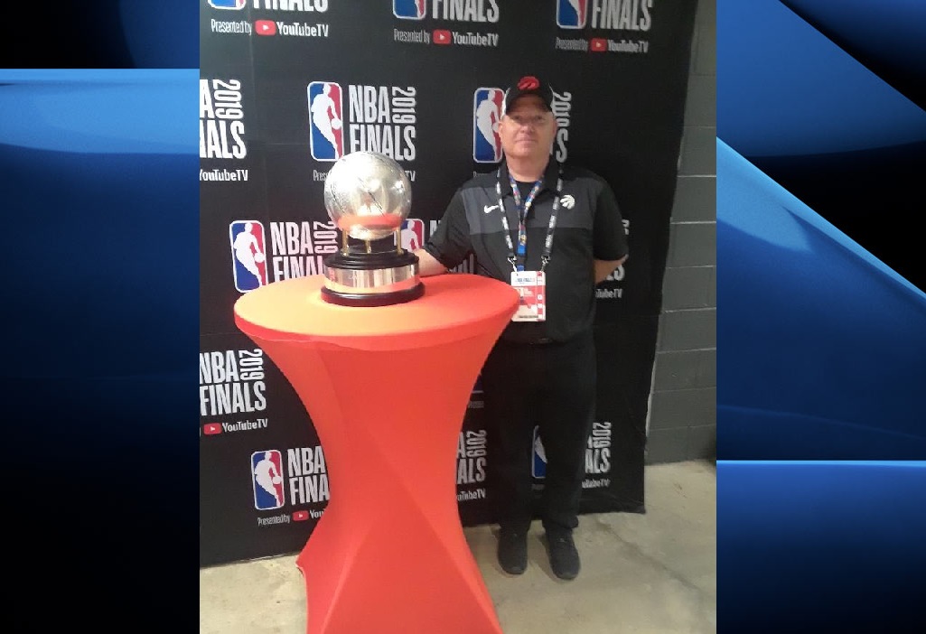 Karl Toulouse poses with the trophy awarded to the NBA Eastern Conference Champions.