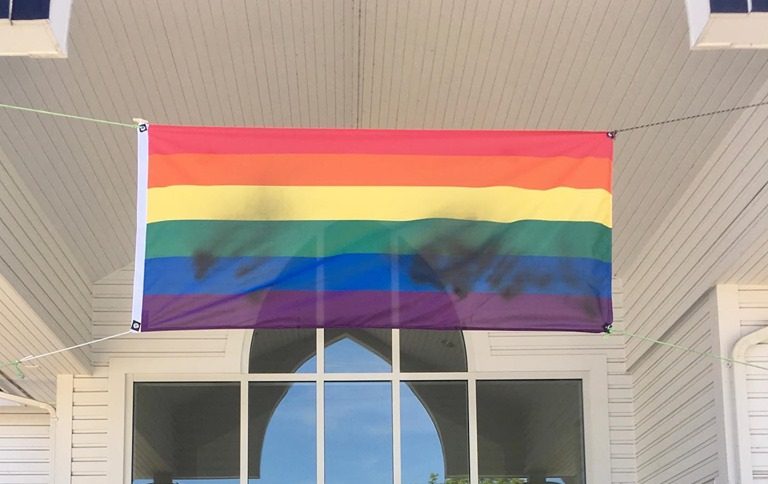 The Pride flag hanging above the front steps of Ladner United Church Saturday, June 15, 2019, shortly after it was discovered sprayed with black paint. It's the second time a Pride flag has been defaced at the church in 12 days.