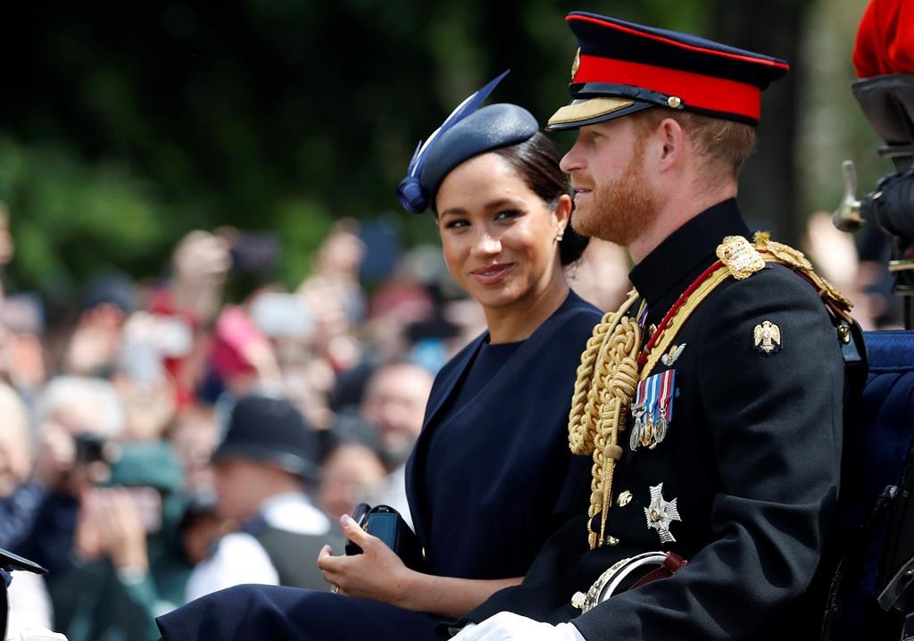 Meghan Markle and Prince Harry ride in a carriage to attend the annual Trooping the Colour Ceremony in London in this file photo.