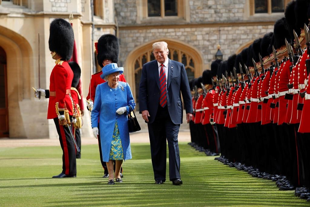 In this Friday, July 13, 2018 file photo, U.S. President Donald Trump and Queen Elizabeth inspect the Guard of Honour at Windsor Castle in Windsor, England.