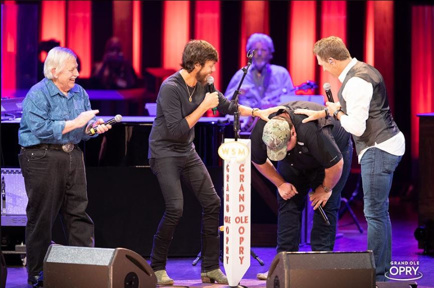 Luke Combs being inducted into the Grand Ole Opry by Craig Morgan, Chris Janson and John Conlee.