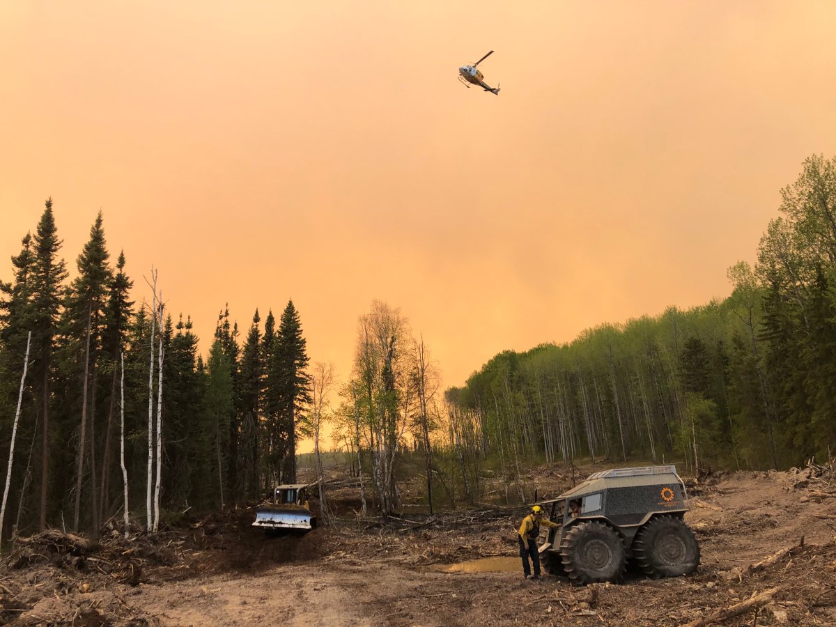 Alberta fire crews seen fighting the McMillan Complex wildfire in early June. 