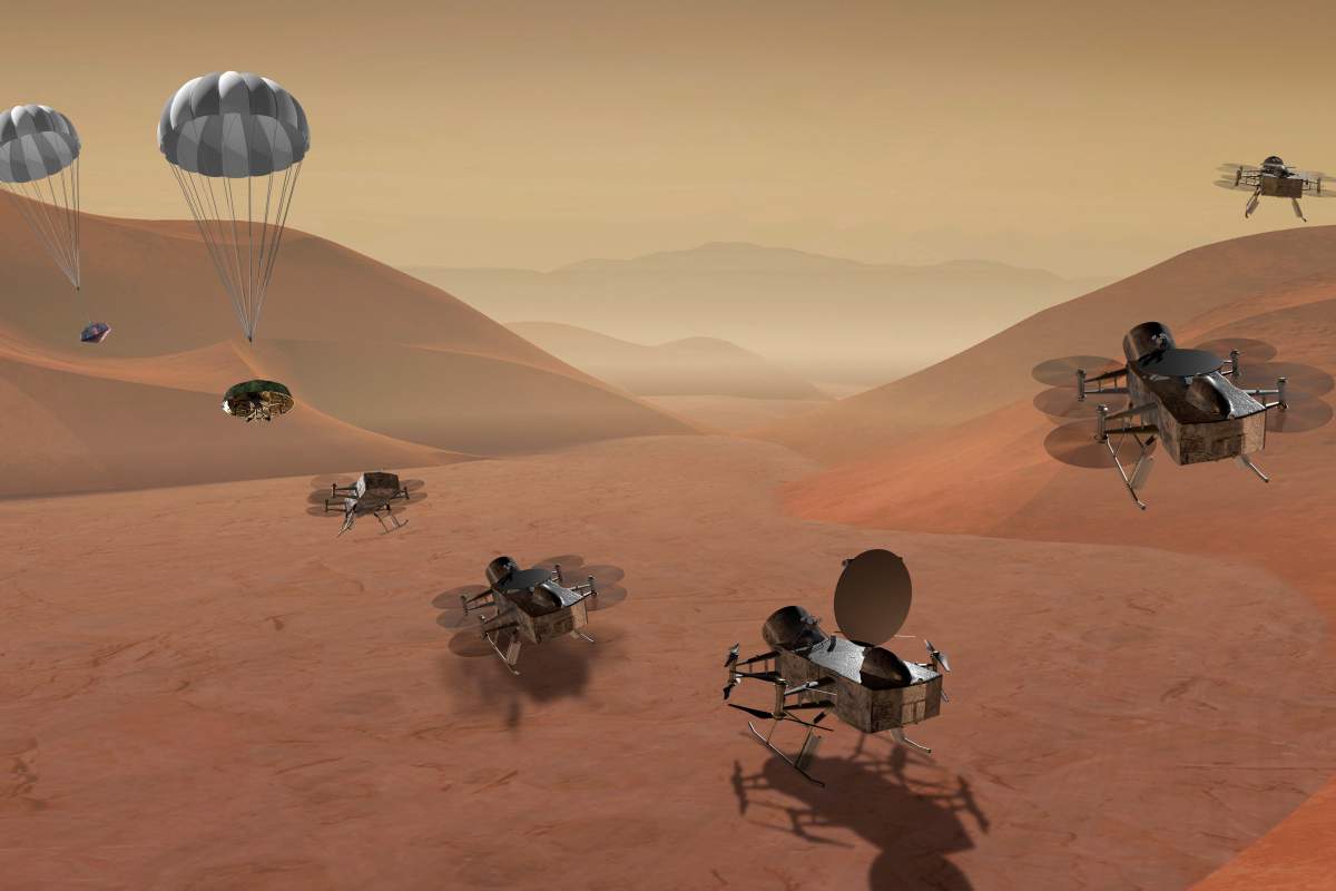 This artist’s rendering made available by NASA shows multiple views of the Dragonfly dual-quadcopter lander.