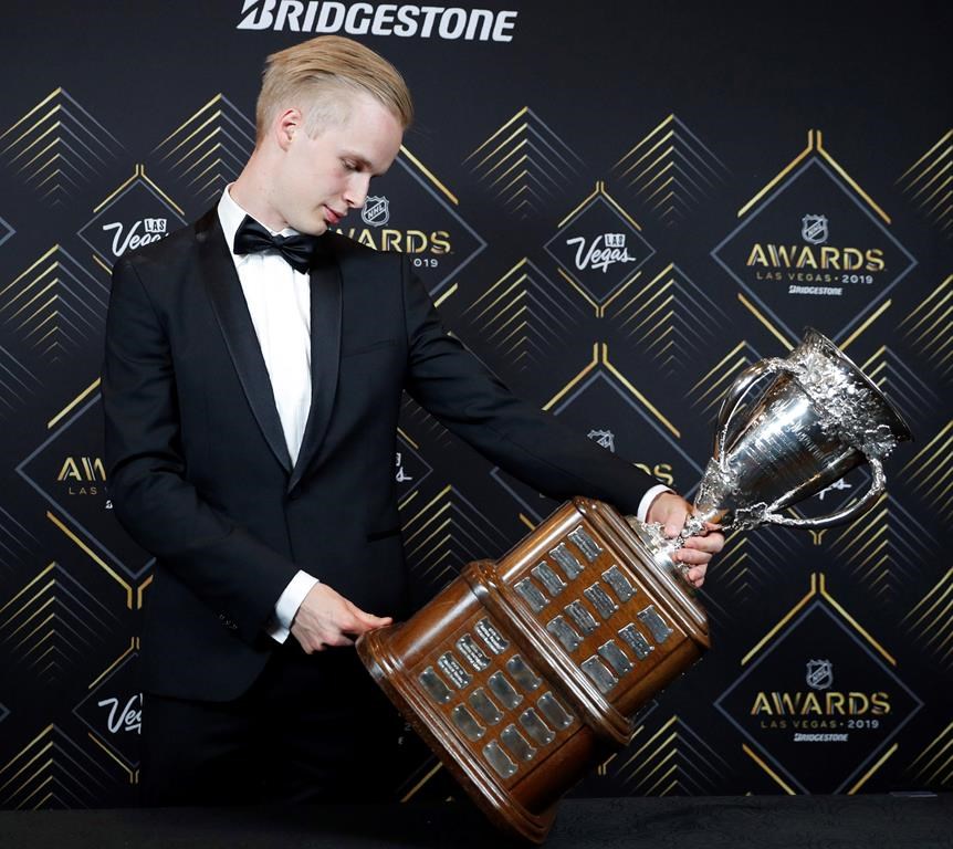 Vancouver Canucks' Elias Pettersson looks at the Calder Memorial Trophy after winning the honour at the NHL Awards, Wednesday, June 19, 2019, in Las Vegas.