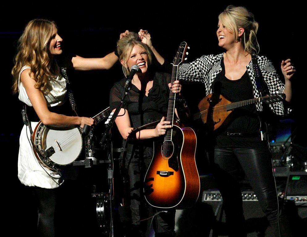 Emily Strayer, left, and Martie Maguire, right, adjust Natalie Maines’ hair as the Dixie Chicks perform at the new Nokia Theatre in Los Angeles in 2007. The award-winning group took to Instagram on Tuesday, June 25, 2019 to tease a new album. It would be their first in 13 years. (AP Photo/Gus Ruelas, file)