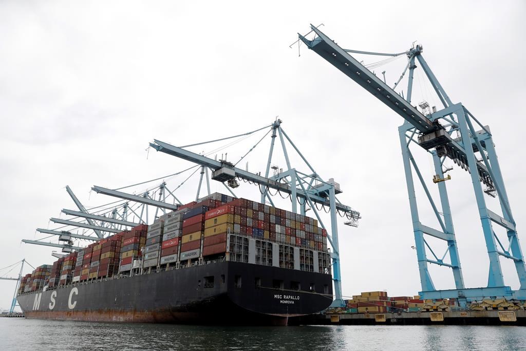 FILE - In this June 19, 2019, file photo a cargo ship is docked at the Port of Los Angeles in Los Angeles.