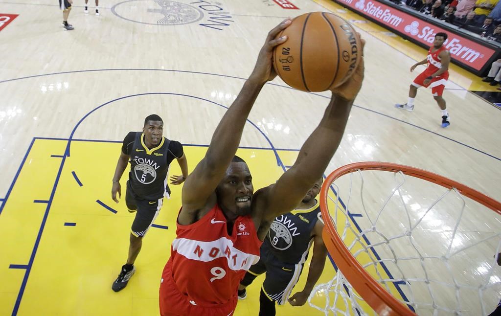 Toronto Raptors center Serge Ibaka (9) dunks against the Golden State Warriors during the second half of Game 4 of basketball's NBA Finals in Oakland, Calif., Friday, June 7, 2019.