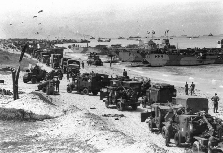 Troops and landing craft occupy a Normandy beach operated by the Royal Canadian Navy Beach Commando shortly after the D-Day landing.