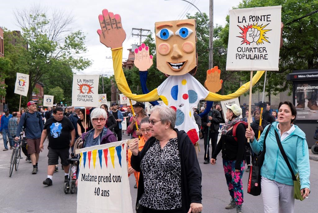 Community groups march in the Montreal district of Pointe-Saint-Charles on Thursday, June 13, 2019.