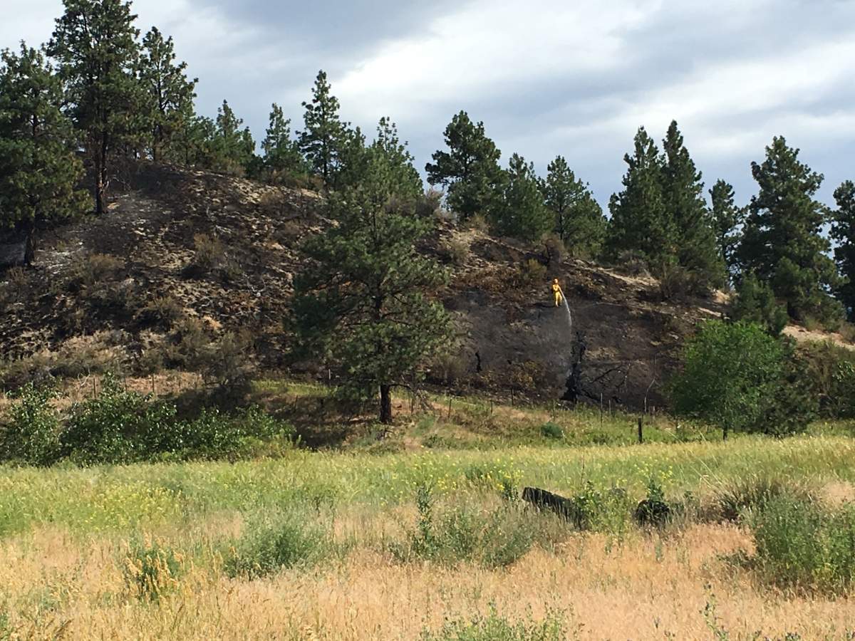 Crews mop up after a fire on Penticton Indian Band land Wednesday morning.