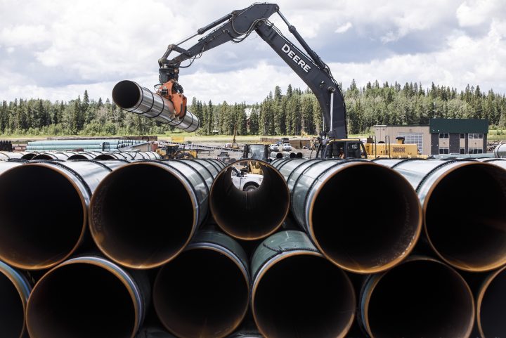 Pipe for the Trans Mountain pipeline is unloaded in Edson, Alta. on Tuesday, June 18, 2019.