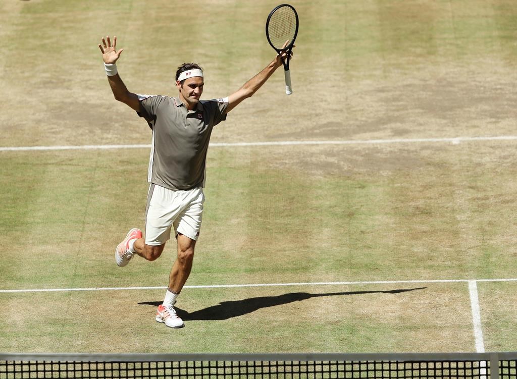 Swiss Roger Federer celebrates after winning the tennis ATP final against Belgium David Goffin in Halle, Germany, Sunday, June 23, 2019.