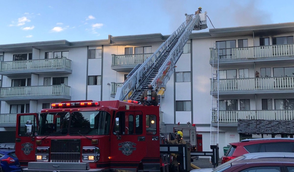 Crews work to knock down  a fire at a multi-unit apartment complex in Saanich on Friday morning. 