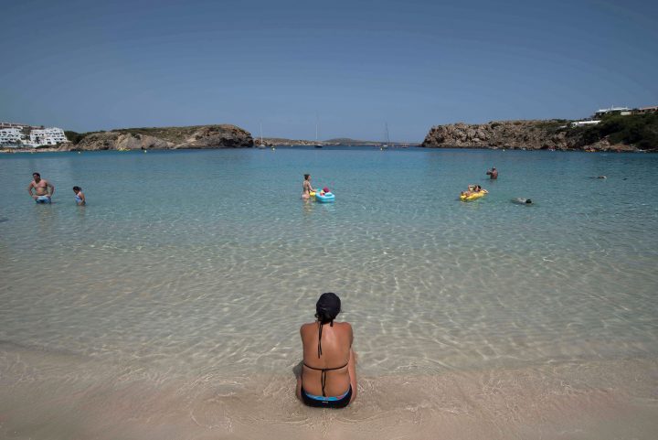 Bathers refresh themselves at Arenal Dien Castell beach in Menorca, Spain, on June 26, 2019.