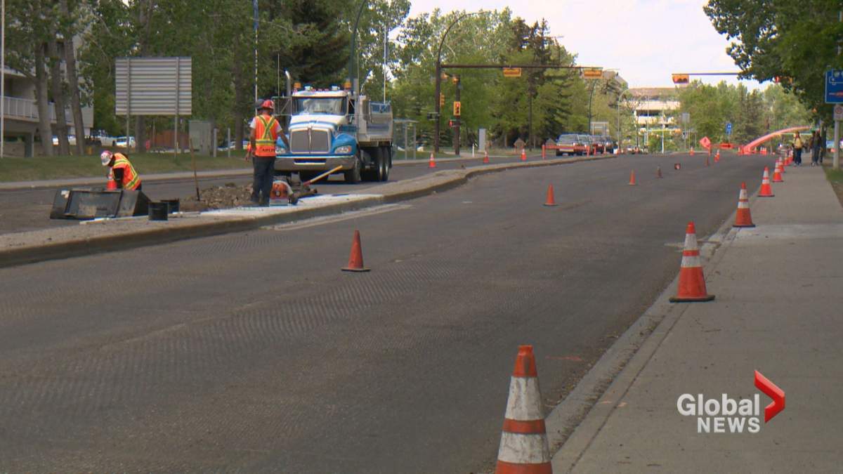 A crew is seen paving a stretch of road in Calgary on Wednesday, June 5.