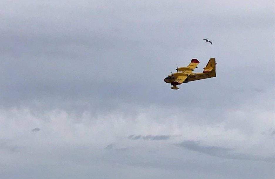 A water bomber seen earlier Friday helping to fight the Traverse Bay forest fire.