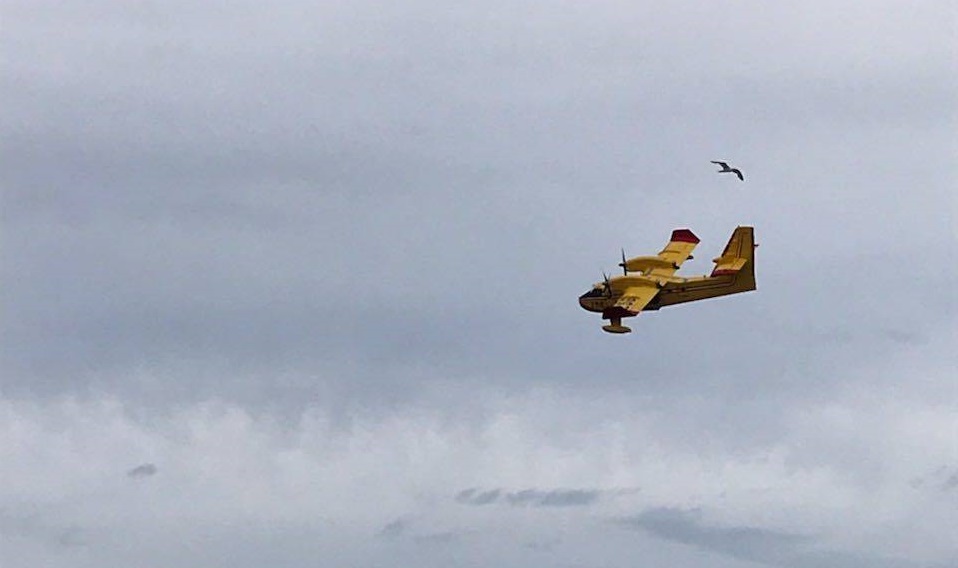 A water bomber seen earlier Friday helping to fight the Traverse Bay forest fire.