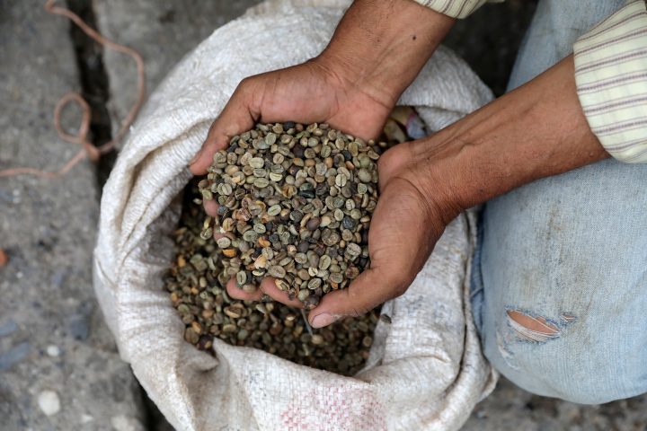 A man displays coffee beans, used for bartering, on a street in Guarico, Venezuela April 24, 2019.