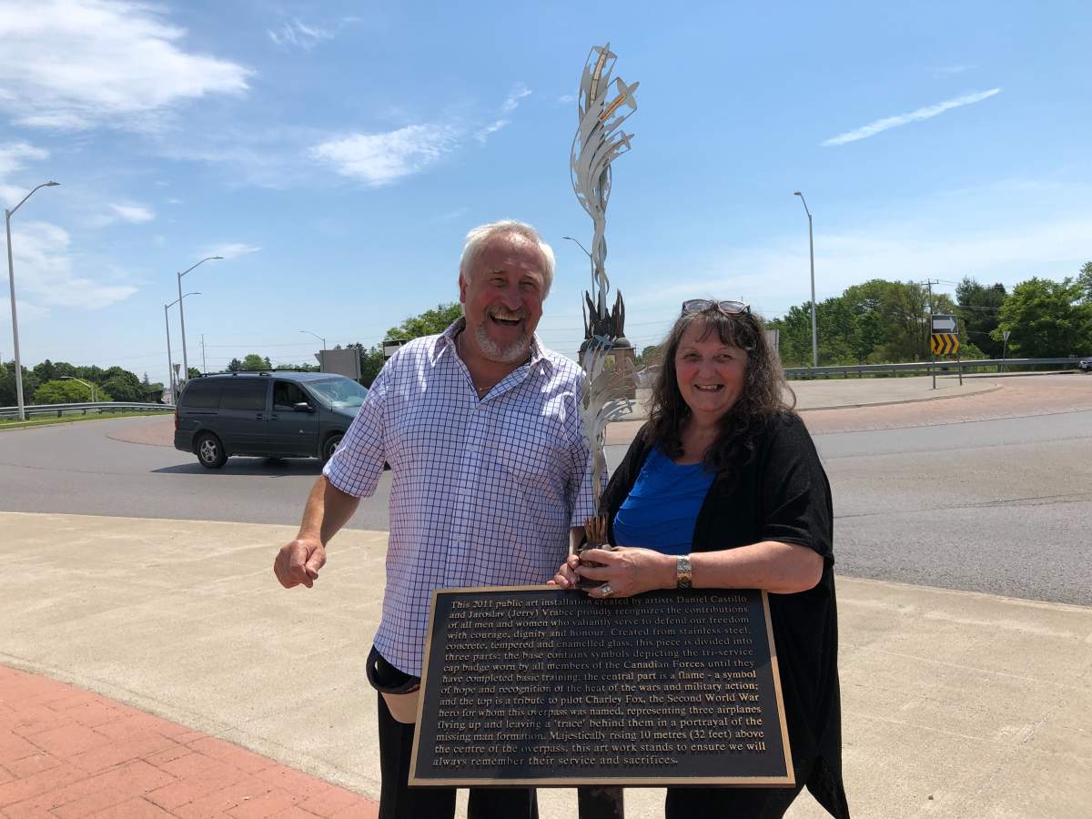 The memorial's co-creator Jerry Vrabec smiles alongside Charley Fox's daughter, Sue.