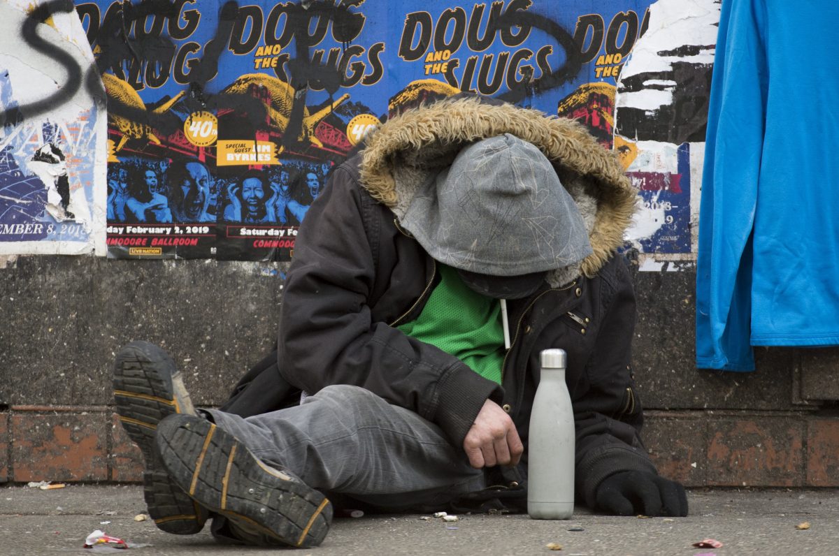 A man sits on a sidewalk along East Hastings Street in Vancouver's Downtown Eastside, Thursday, Feb 7, 2019. A new study from the B.C. Centre for Substance Use found staggering income assistance payments could help curb high drug use on so-called "Welfare Wednesdays," but could also lead to other dangers.