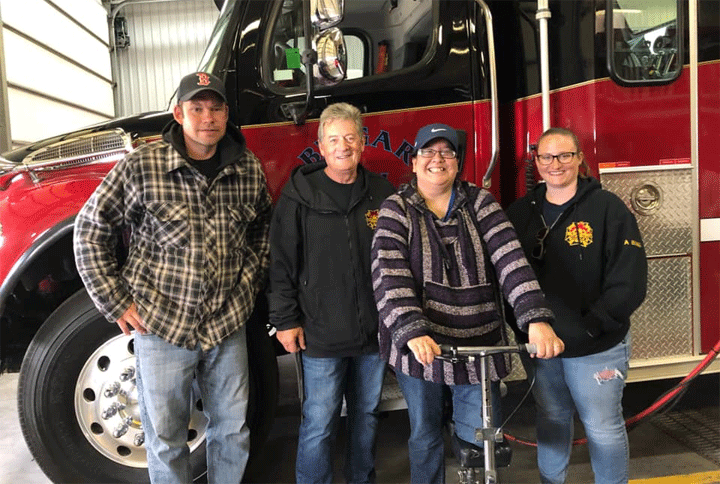 Chrissy Gamble (second from right), who fell down a well, visited members of the fire department that helped rescue her in September 2018.