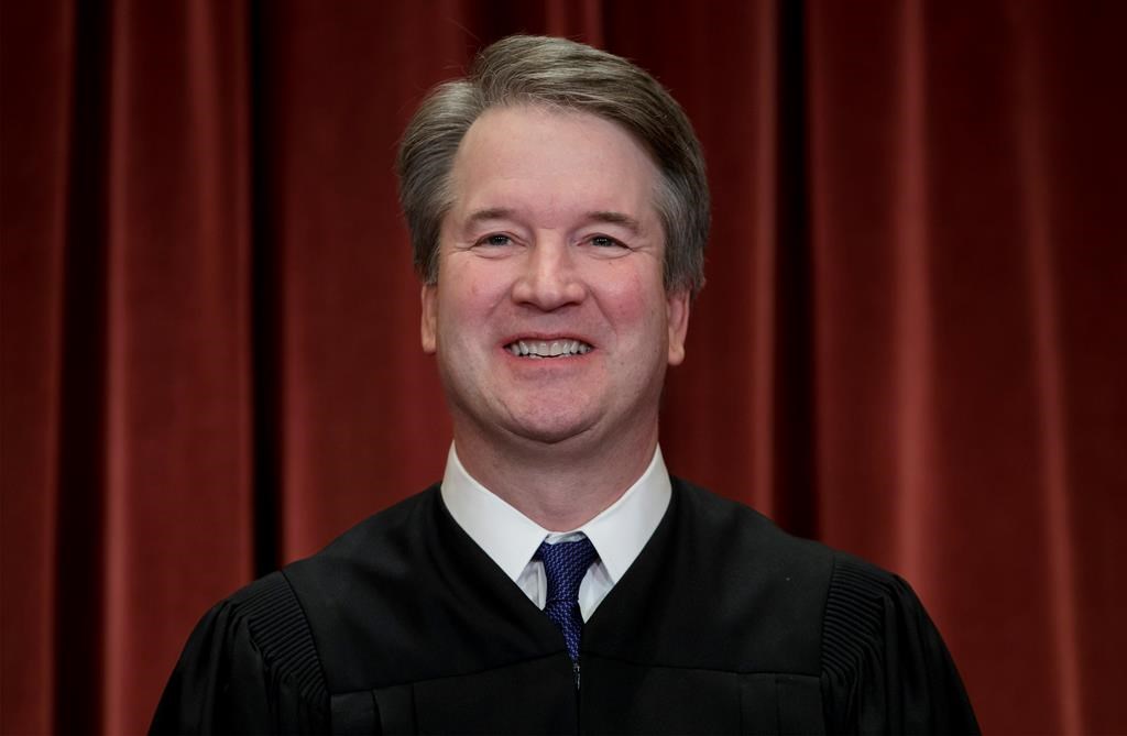 In this Nov. 30, 2018, file photo Associate Justice Brett Kavanaugh sits with fellow Supreme Court justices for a group portrait at the Supreme Court Building in Washington.