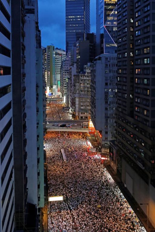 Protesters march in a rally against the proposed amendments to an extradition law in Hong Kong, Sunday, June 9, 2019.