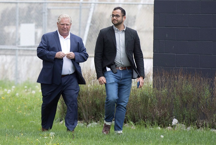 Ontario PC Leader Doug Ford and his Deputy Chief of Staff Amin Massoudi, right, return from a private chat following a campaign event in Sault Ste. Marie, Ont., on Friday, June 1, 2018. 
