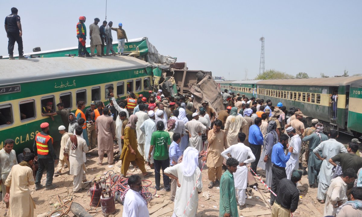 Residents and rescue workers gather near the site after a passenger train collided with a cargo train in Sadiqabad, Pakistan July 11, 2019. 