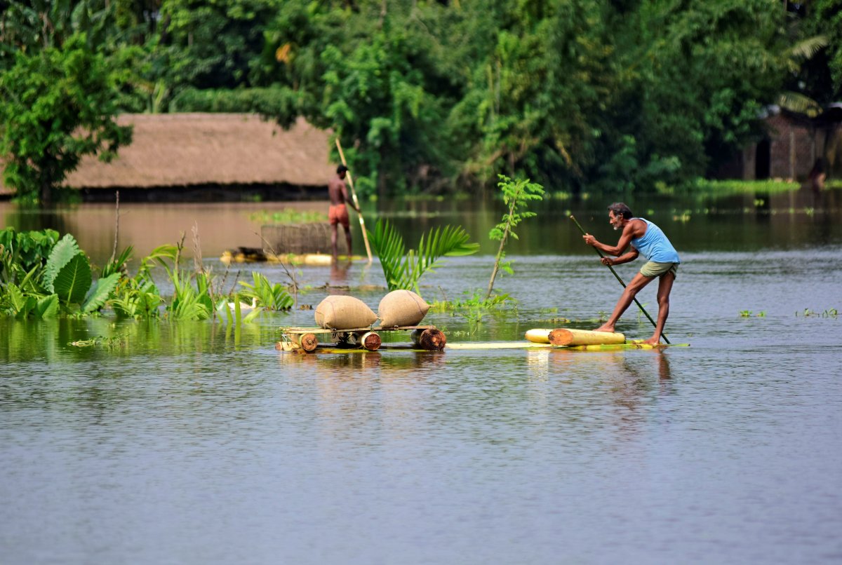 A man uses a makeshift raft to move his paddy to a safer place in a flooded area in Morigaon district in the northeastern state of Assam, India, July 16, 2019. 