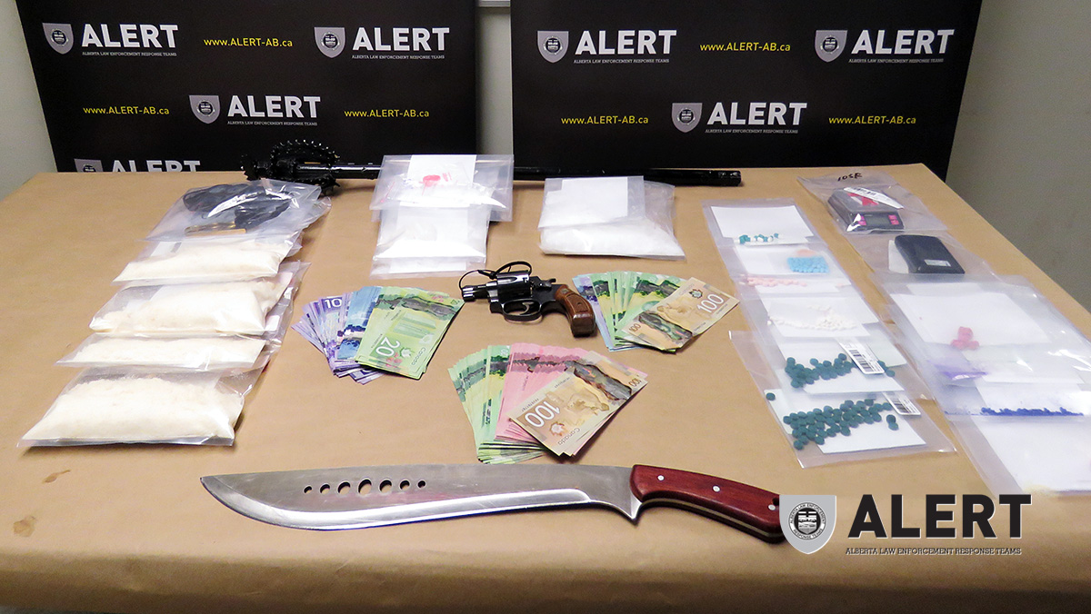 Drugs, weapons and cash seized by ALERT are displayed in this handout photo. 