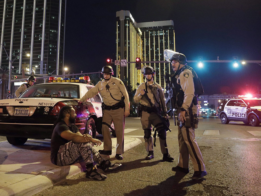 In this Oct. 1, 2017 file photo, police officers stand at the scene of a shooting near the Mandalay Bay resort and casino on the Las Vegas Strip in Las Vegas, Nev.