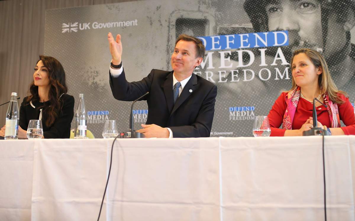 International human rights lawyer Amal Clooney, left, Britain's Foreign Secretary Jeremy Hunt and Canada's Minister of Foreign Affairs Chrystia Freeland, right, attend a meeting in Dinard, Brittany, Friday, April 5, 2019. 