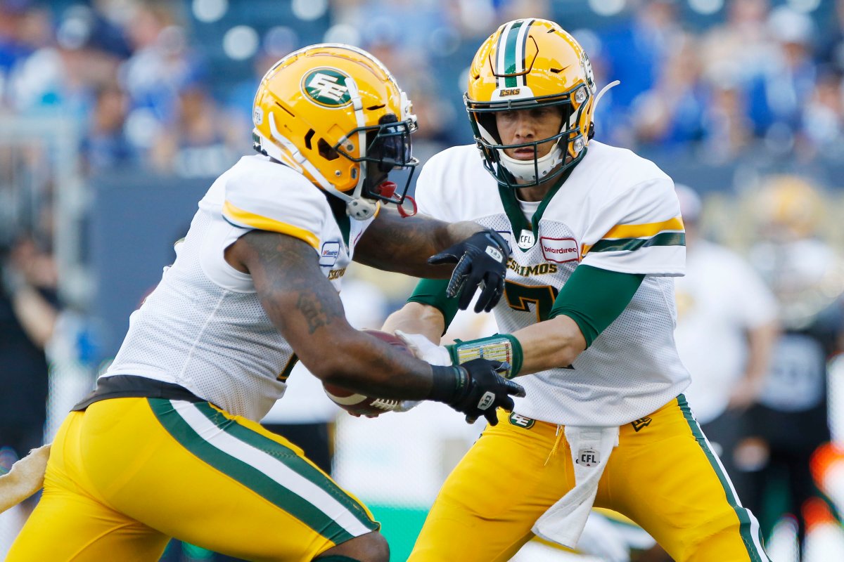 Edmonton Eskimos quarterback Trevor Harris (7) hands off to C.J.Gable (2) against the Winnipeg Blue Bombers during the first half of CFL action in Winnipeg Thursday, June 27, 2019. 